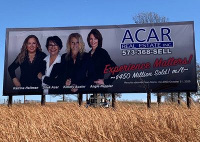 Image of a billboard for Acar Real Estate.