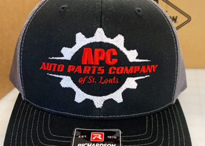 Photo of embroidered cap for APC Auto Parts Company of St. Louis.