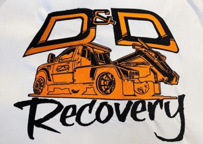 Photograph of an embroidered logo for D and D Recovery.