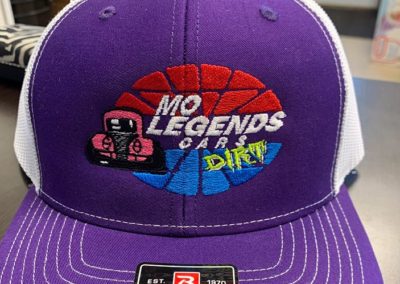 Photo of a purple hat with MO Legends Cars logo embroidered on the front