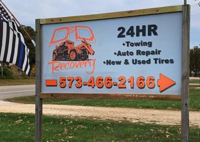 Image of an outdoor sign for D and D Recovery