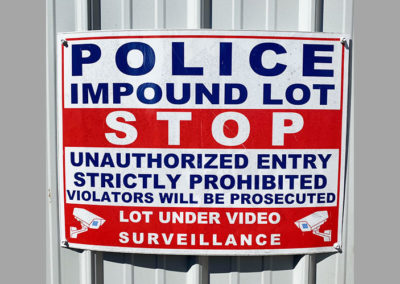 Photo of an outdoor sign for a police impound lot