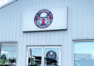 Image of a building with an outdoor sign for Torque Motorsports.
