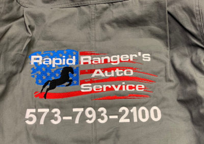 Photo of embroidered jacket for Rapid Ranger's Auto Service.