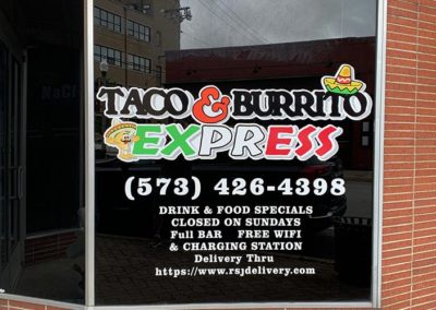 Image showing vinyl decal and lettering applied as signage on a business window