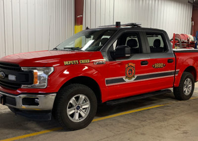 An image showing how vinyl was added to existing graphics on a fleet vehicle for St. Robert Fire and Rescue.