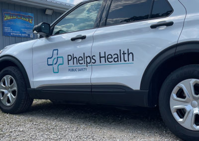Picture of a car with a decal and lettering for Phelps Health Public Safety.