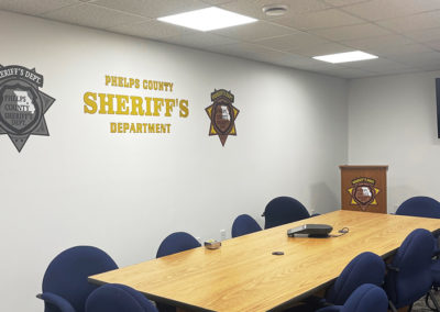 Picture of an interior wall with vinyl graphics for the Phelps County Sheriff's Department.